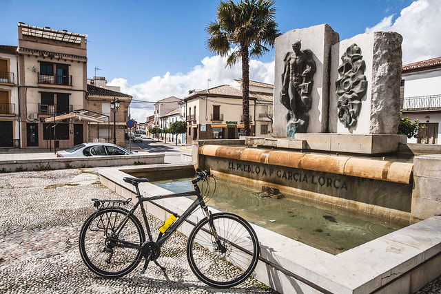 Touring bicycle parked in Fuente Vaqueros at the Grcia Lorca monument