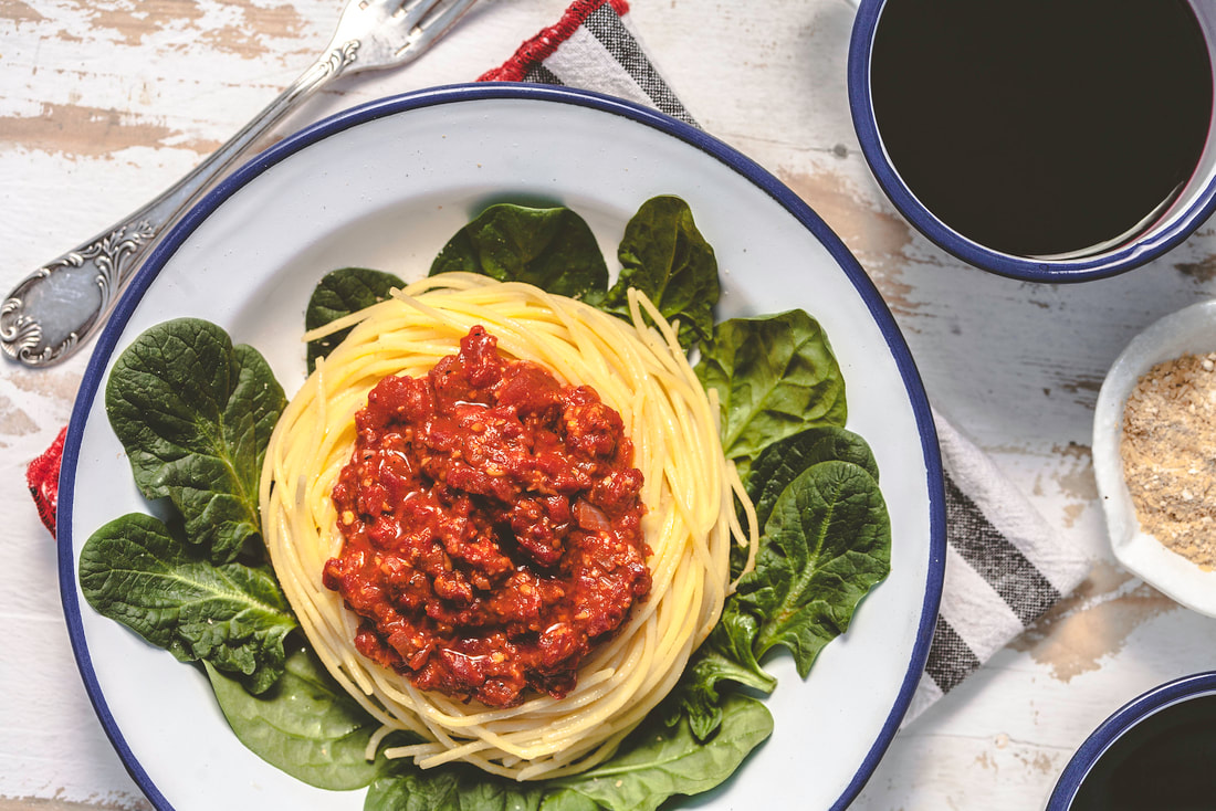Picture of Smoky romesco saouce on spaghetti with spinach leaves