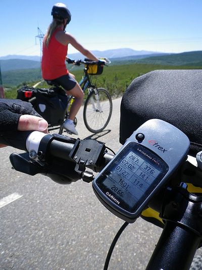 Tour cyclists on the road with a GPS device on the handlebar