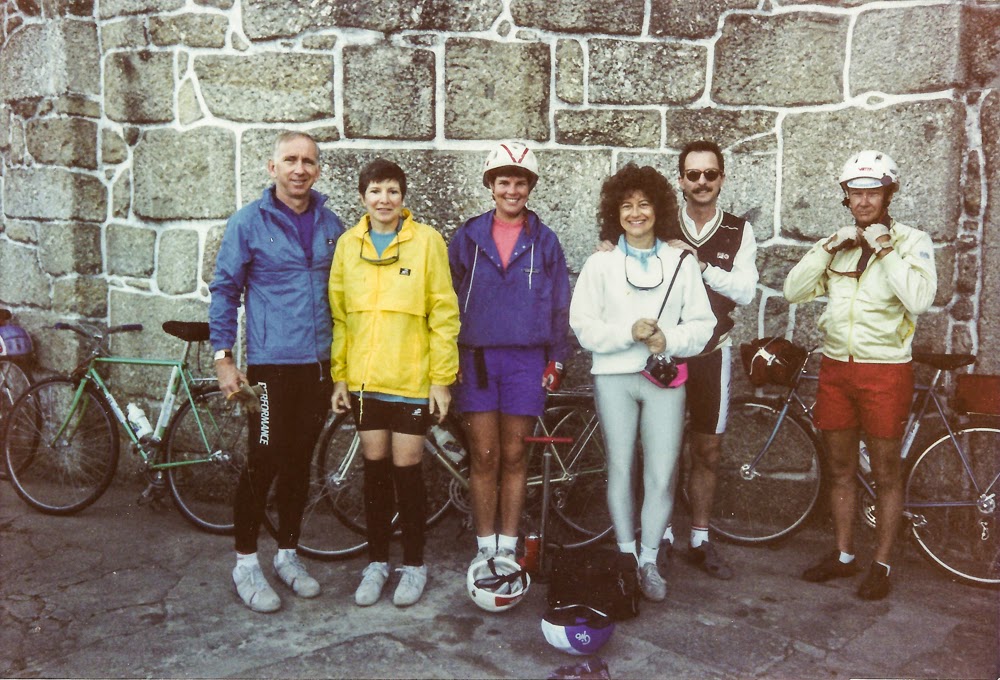 Bicycle tour group standing by an old granite wall in the Minho in Portugal