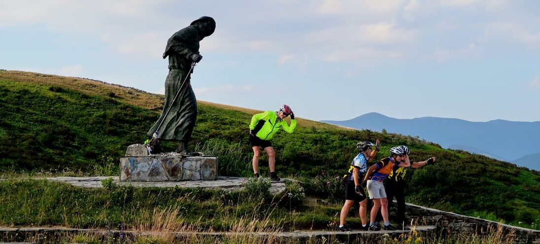 Statue of San Roque and bicycle pilgrims on the Camino de Santiago